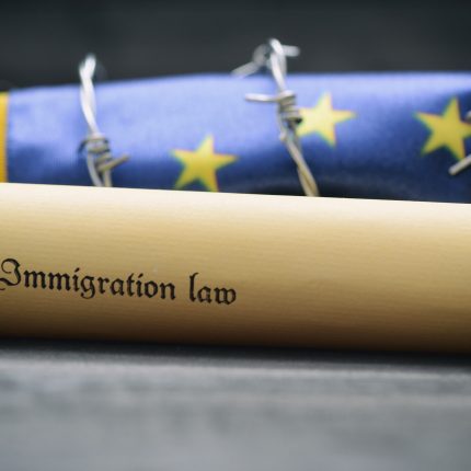 European,Union,Flag,,Barbed,Wire,And,Immigration,Law,On,Black